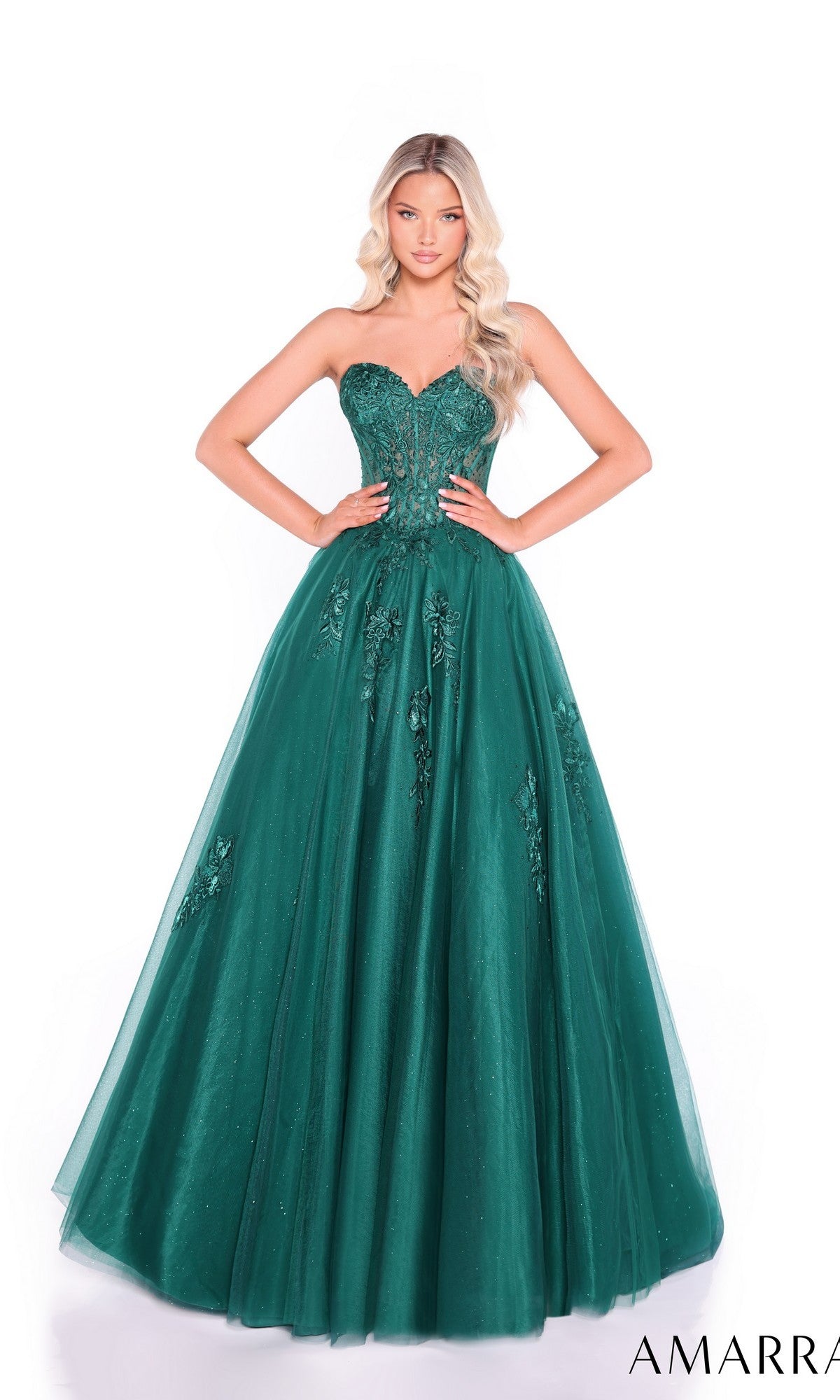 A woman wears the Lace-Up Strapless Prom Ball Gown: Amarra 89011—an emerald green, floor-length dress with a sweetheart bodice and floral embellishments for elegant style.